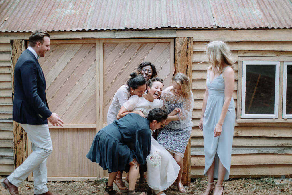 Sarah's attendants gather around her, preparing to lift her for a group portrait.
