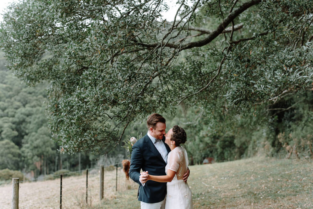 Sarah and Jye hold each other beneath a branch at Strathvea.