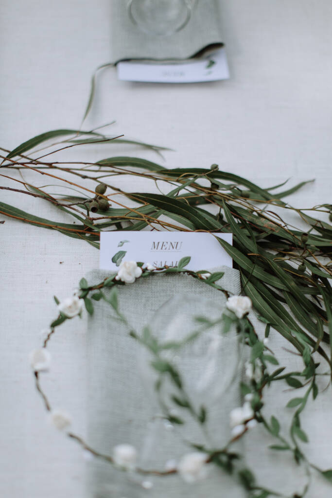 A menu, floral headpiece and eucalyptus table runner decorate the reception at Strathvea Guesthouse.