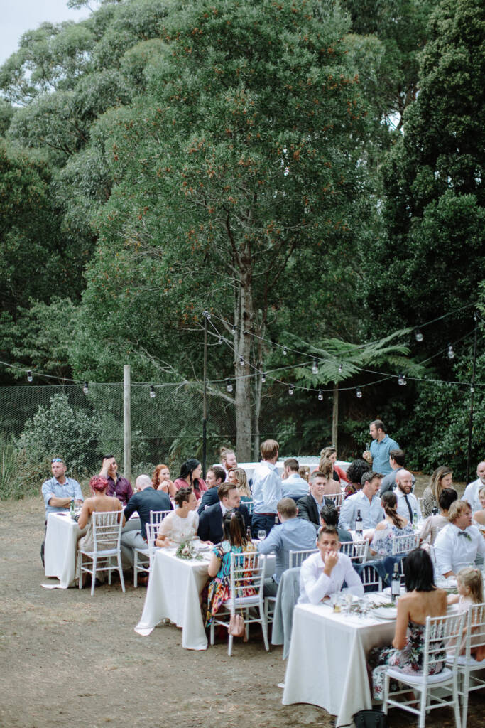 Long dining tables are arranged for an alfresco garden reception at Strathvea Guesthouse in the Yarra Valley.