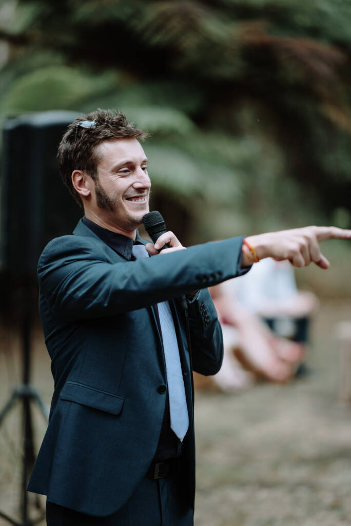 A guest addresses the outdoor reception with a microphone at Strathvea Guesthouse.