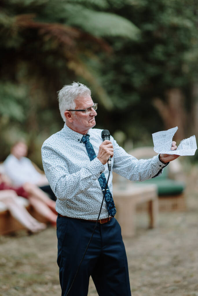 A guest delivers a speech beside the outdoor tables at Strathvea Guesthouse.
