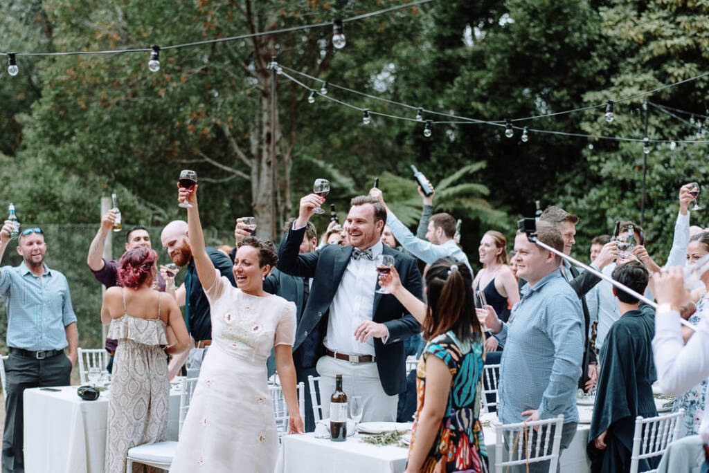 Glasses are raised for a toast at the outdoor reception at Strathvea.
