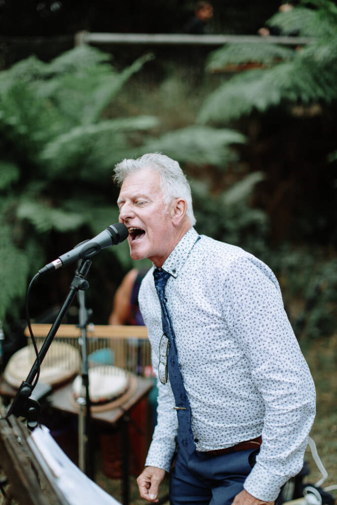 A guest sings into a microphone at the Strathvea reception.