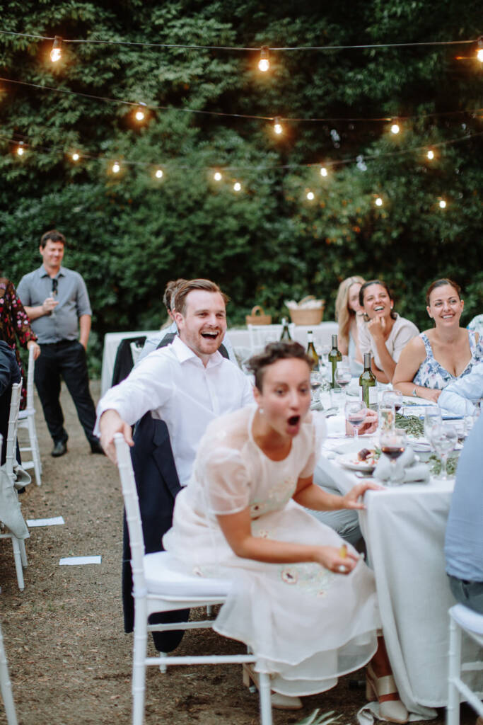 Sarah reacts with an open-mouthed smile during the reception.