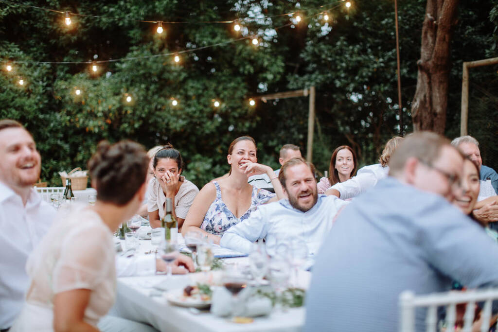 Guests laugh together during the reception speech.
