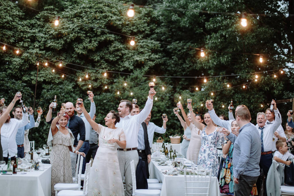 Guests raise their glasses for a reception toast.