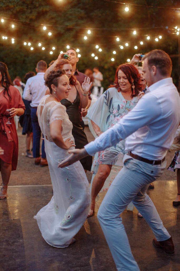 Sarah, Jye and their guests dance beneath festoon lights at Strathvea.