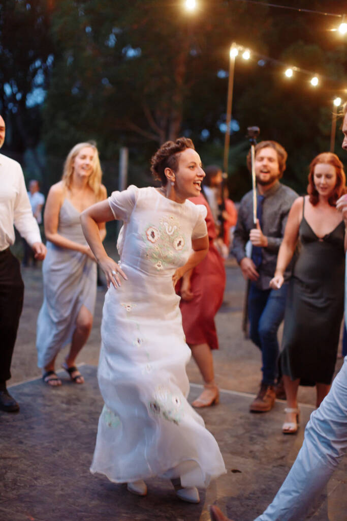Sarah dances with her hands on her hips among guests at Strathvea Guesthouse.