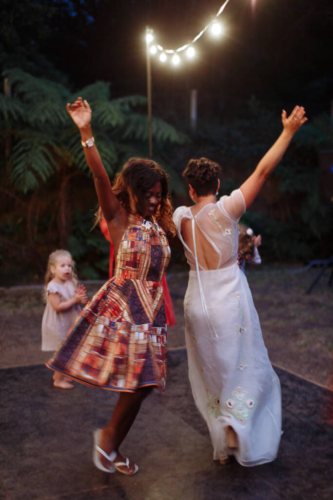 Sarah and an attendant dance back to back with their arms raised at Strathvea.