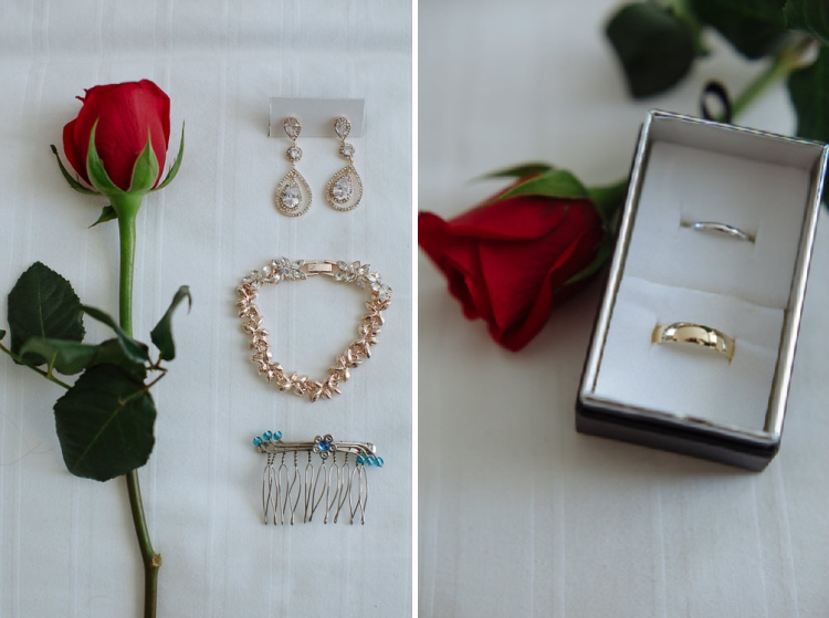 Two frames, a red rose with teardrop earrings, bracelet and comb, then two wedding bands in a box.