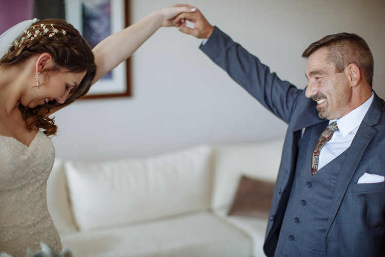 Shannon laughs as the man with the moustache holds her hand high in a twirl.