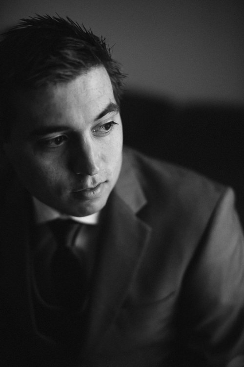 Black-and-white close-up of Luke looking to one side, his face partly in shadow.
