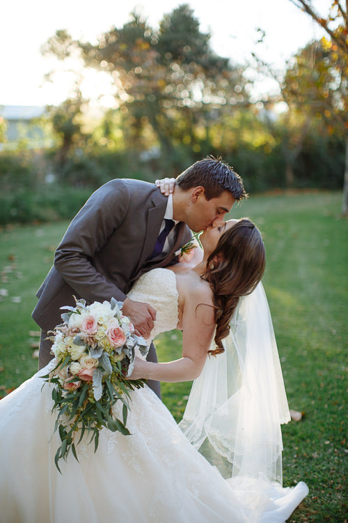 Luke dips Shannon for a kiss on the lawn at Sunnybrae Estate.