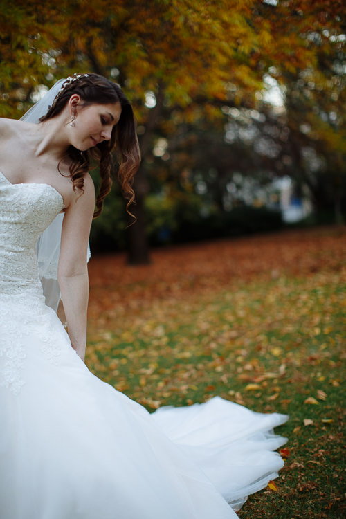 Shannon looks down at her gown, its train extending across the lawn at Sunnybrae Estate.