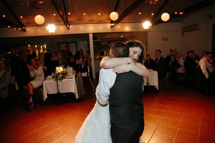 Shannon hugs a grey-waistcoated man on the dance floor at Sunnybrae.