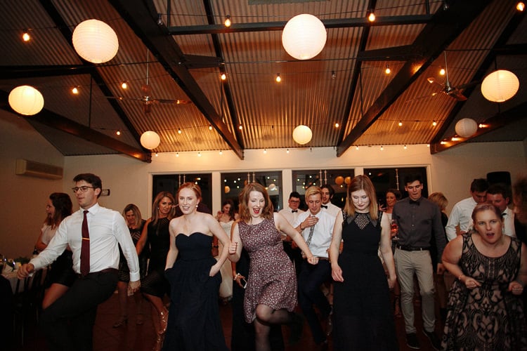 Guests perform a line dance beneath paper lanterns at Sunnybrae Estate.