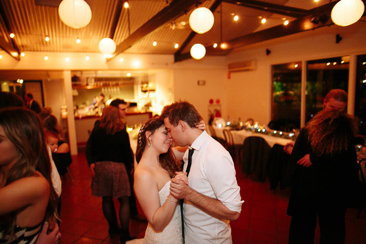 Shannon and Luke dance with foreheads touching near the reception bar at Sunnybrae.