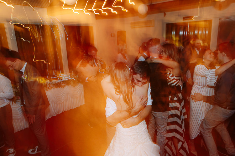 Orange light trails surround Shannon and Luke embracing on the dance floor at Sunnybrae Estate.