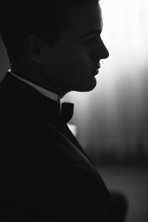A sharp profile silhouette against the sheer curtains