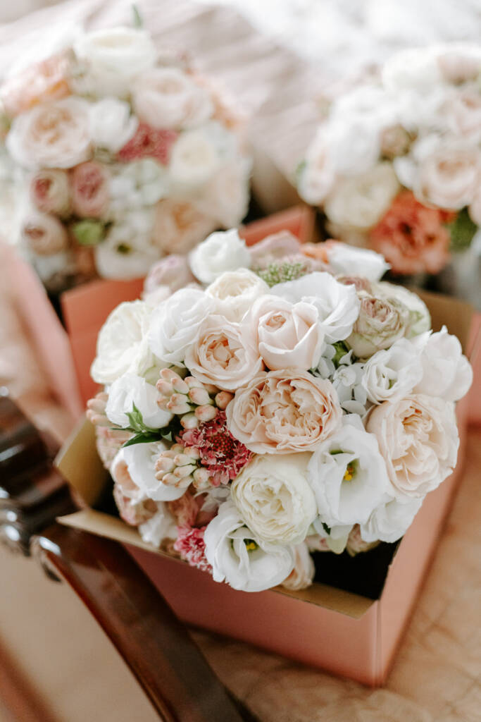Three boxed bouquets of garden roses in blush and cream