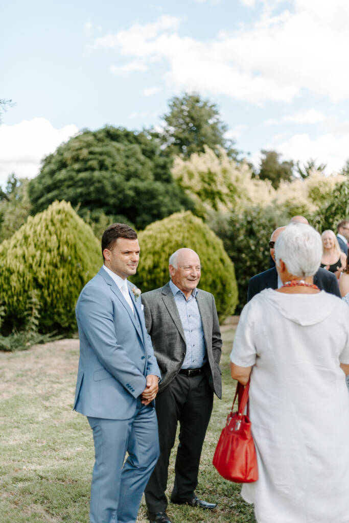 Jarrod chats with an older man and another guest before the ceremony.