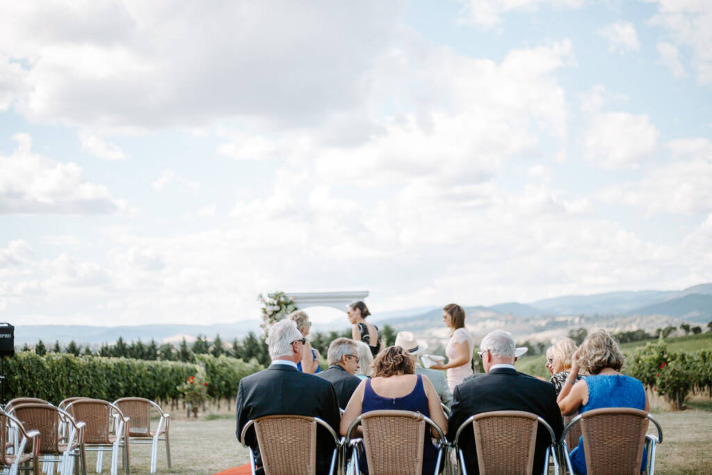 Guests take their seats for Tokar Estate Winery's outdoor ceremony above the vines.