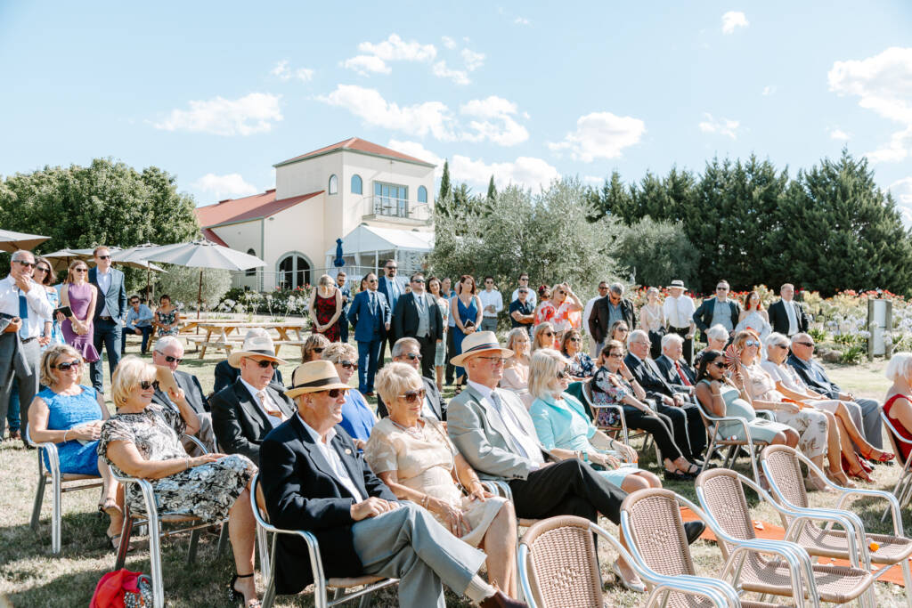 Guests sit outdoors with Tokar Estate Winery's cream tower behind them.
