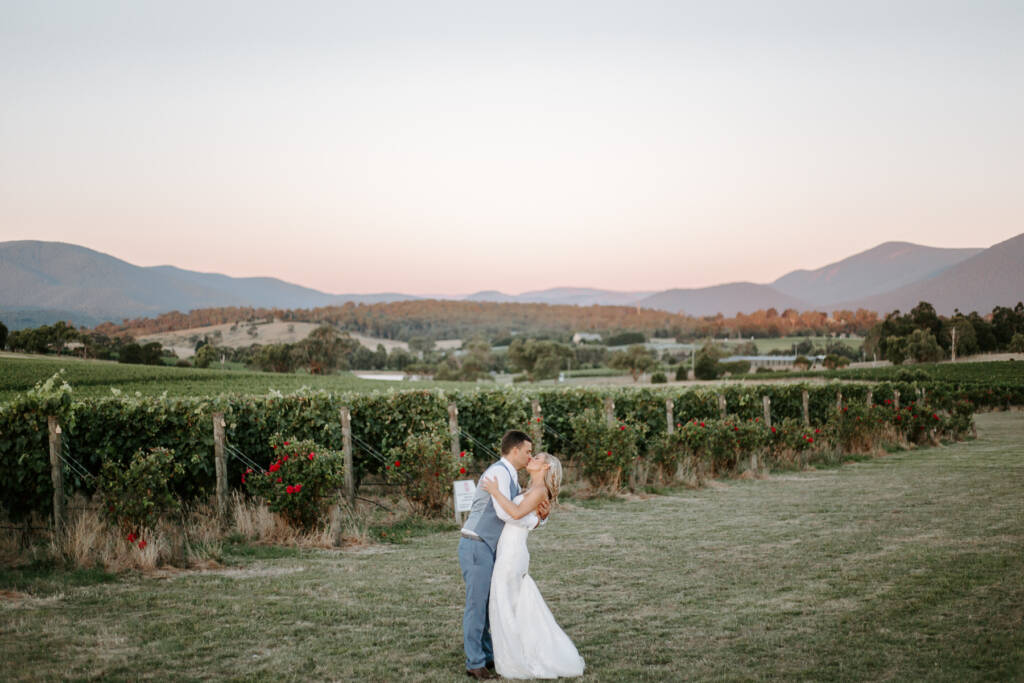 Dusk folds around a kiss in the open paddock at Tokar Estate