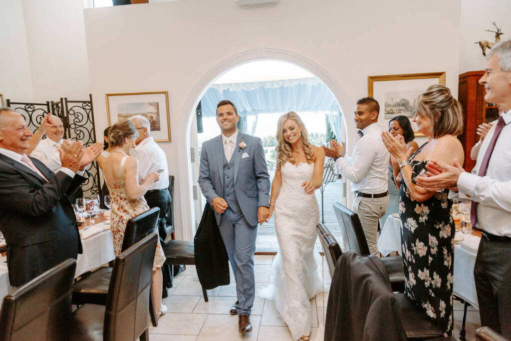 Danni and Jarrod enter Tokar Estate Winery's dining room to applause.