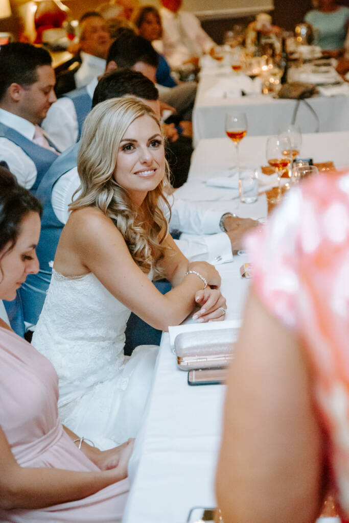 Danni listens closely as someone speaks during the reception.