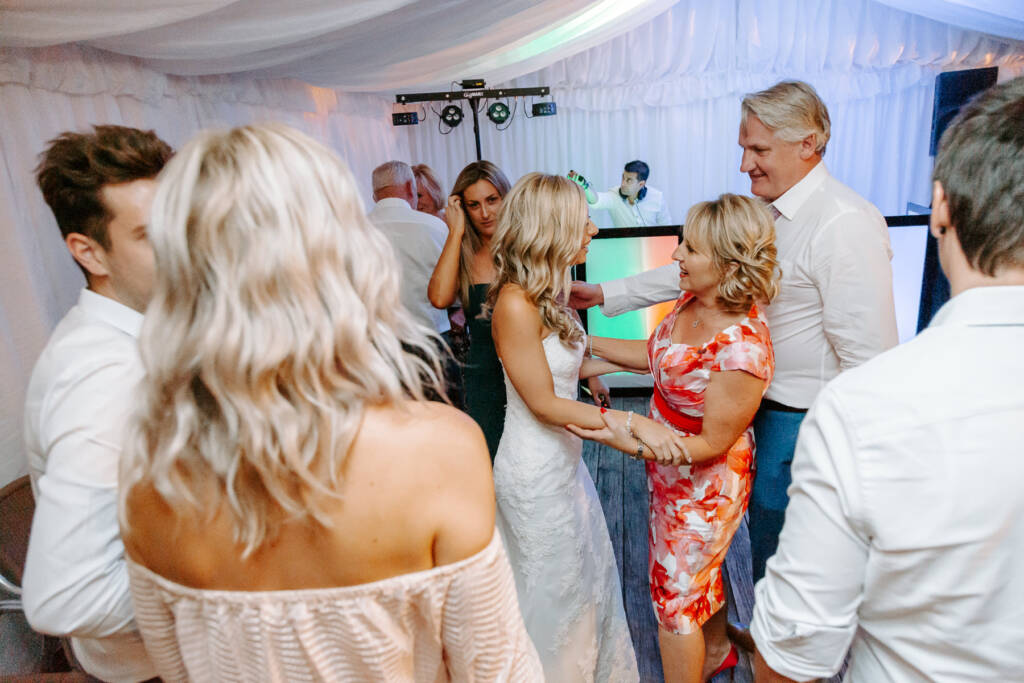 Congratulations pass down the line as the DJ cues the night
