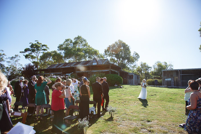 Lindsey crosses the lawn alone toward the old farm sheds as the guests turn.