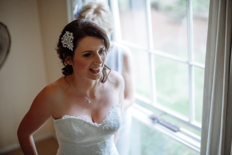 Heidi smiles in her lace gown with a woman standing behind her