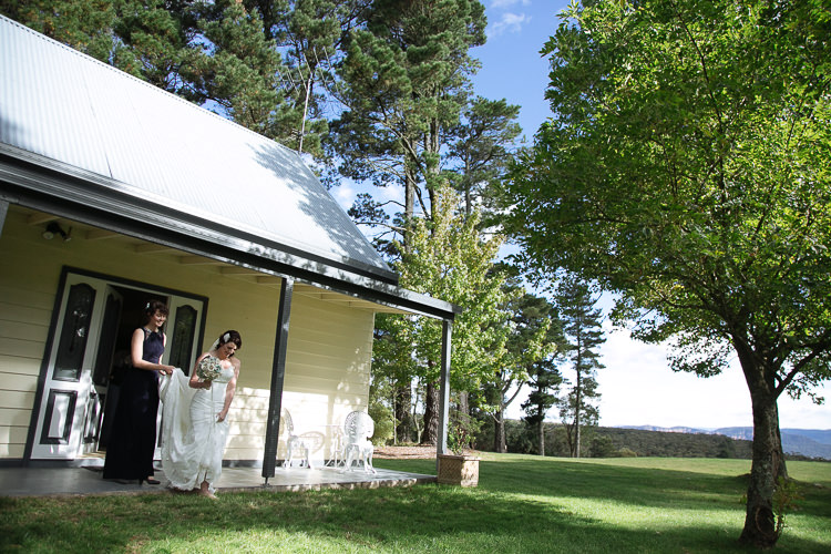 Heidi leaves the cottage verandah at Yester Grange as a woman helps with her train