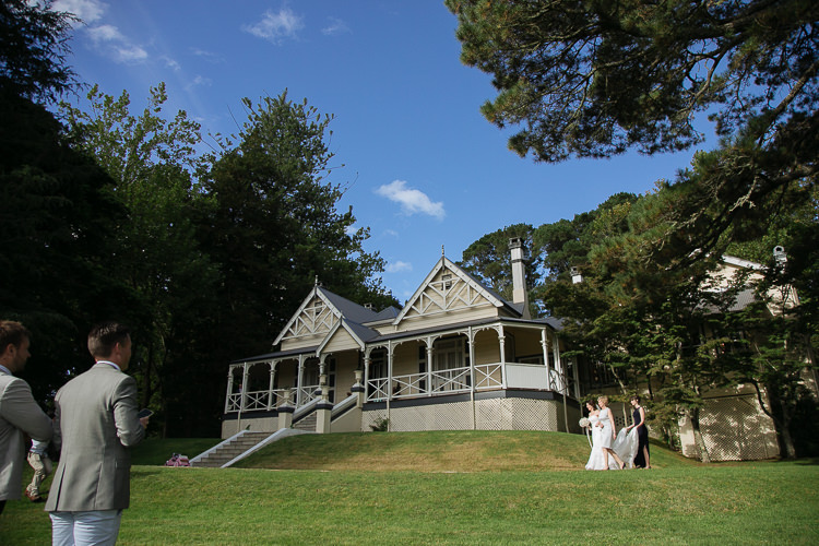 Heidi crosses the lawn with two women in front of Yester Grange Estate's heritage homestead