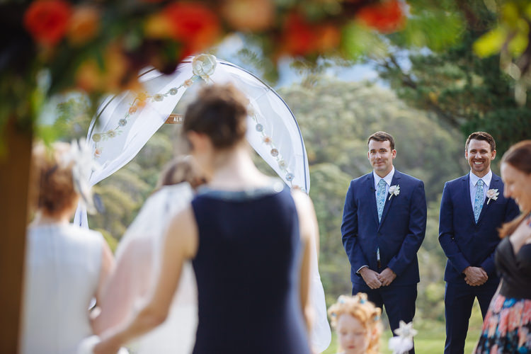 Russell watches Heidi approach the draped ceremony arch at Yester Grange