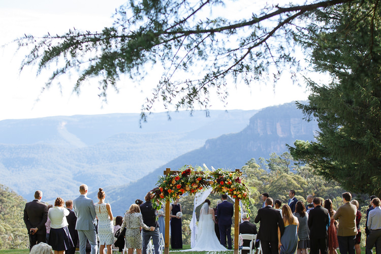 Standing guests surround the ceremony at Yester Grange Estate with Jamison Valley beyond