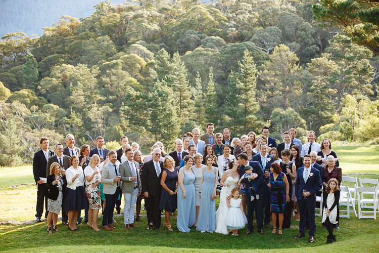 Heidi, Russell and their wedding guests pose on the lawn at Yester Grange