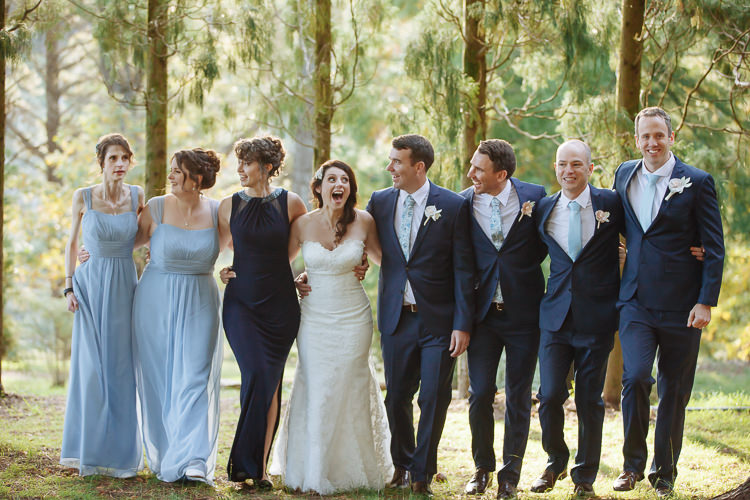 Heidi, Russell and their attendants walk arm in arm through Yester Grange Estate's gardens