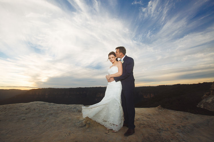Russell embraces Heidi from behind for a sunset photo at Lincoln's Rock in the Blue Mountains