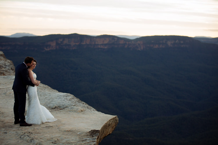Heidi and Russell embrace on the sandstone ledge at Lincoln's Rock above Jamison Valley