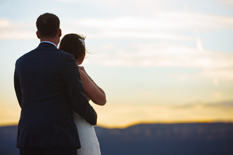 Heidi and Russell look towards the pastel sunset from Lincoln's Rock