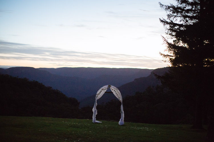 The empty ceremony arch overlooks Jamison Valley at dusk from Yester Grange Estate