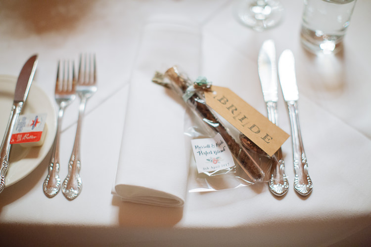 A favour bag and kraft Bride tag rest beside cutlery at Yester Grange
