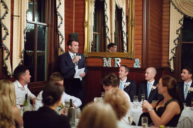Russell holds notes and a microphone during his wedding speech at Yester Grange Estate