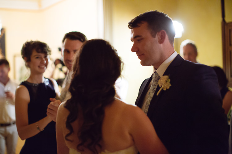 Russell looks towards Heidi as they dance with guests nearby at Yester Grange Estate