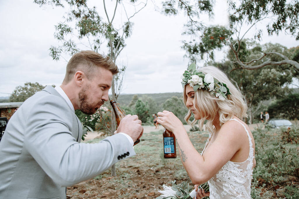 Kelly and Tory clink open beers between the gum trees at Camp Sunnystones, Bacchus Marsh