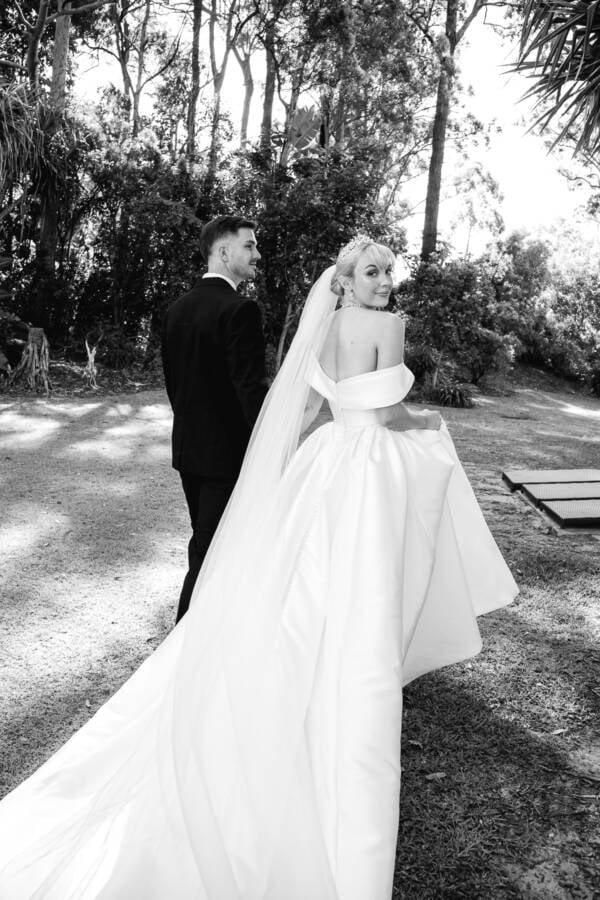 Bride in a full ballgown with a sweeping train on the garden path at InterContinental Sanctuary Cove, Gold Coast