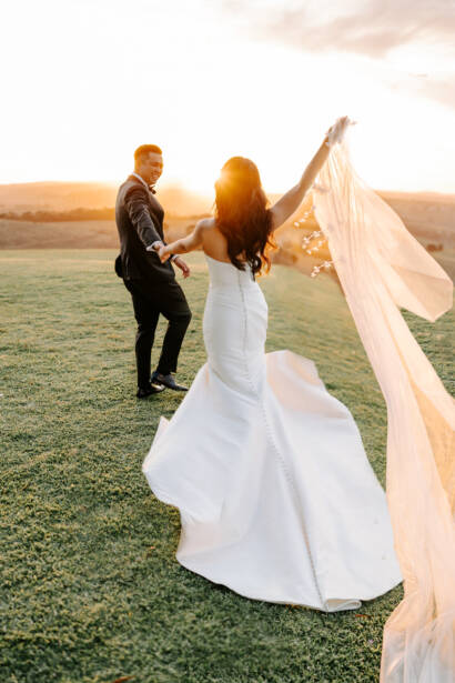 Twirling the veil at sunset across the lawn at Marnong Estate